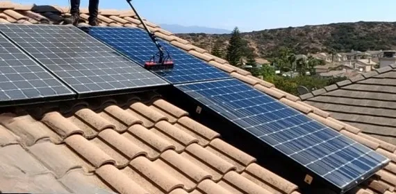 AE Exterior Cleaning team offering solar panel cleaning services on a residential rooftop