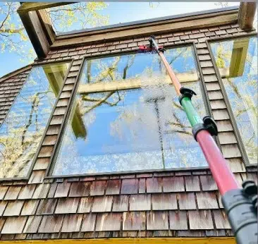 Window cleaning services during residential cleaning with modern tools