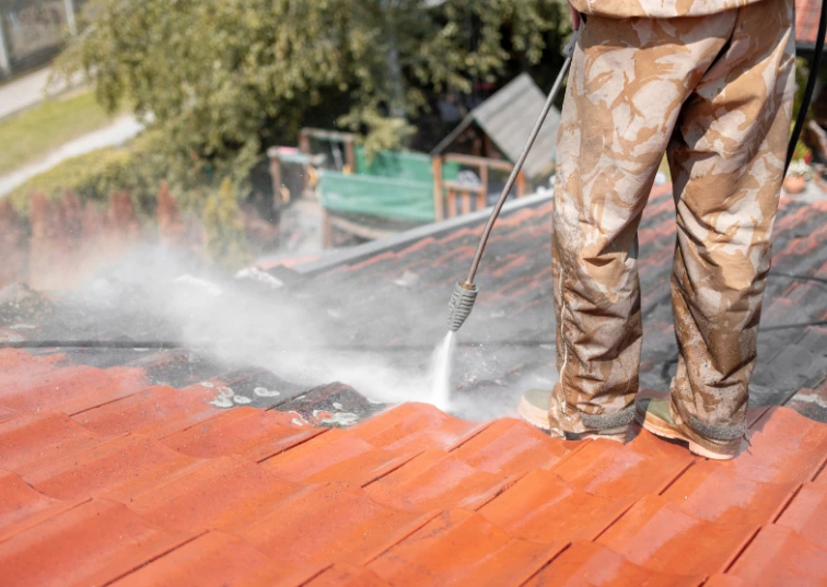 Specialist performing roof cleaning services in Stratford in East London for AE Exterior Cleaning Ltd.