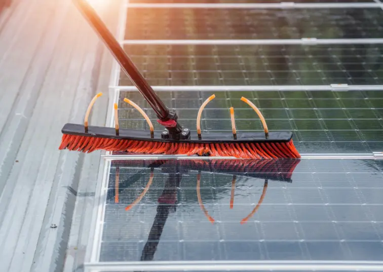 An AE Exterior Cleaning Ltd. team member diligently cleaning solar panels during solar panel cleaning services in Manor Park.